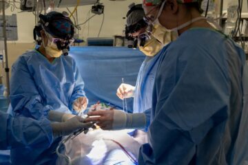 Cirujano observando una pantalla con cirugía guiada por IA que marca un tumor cerebral